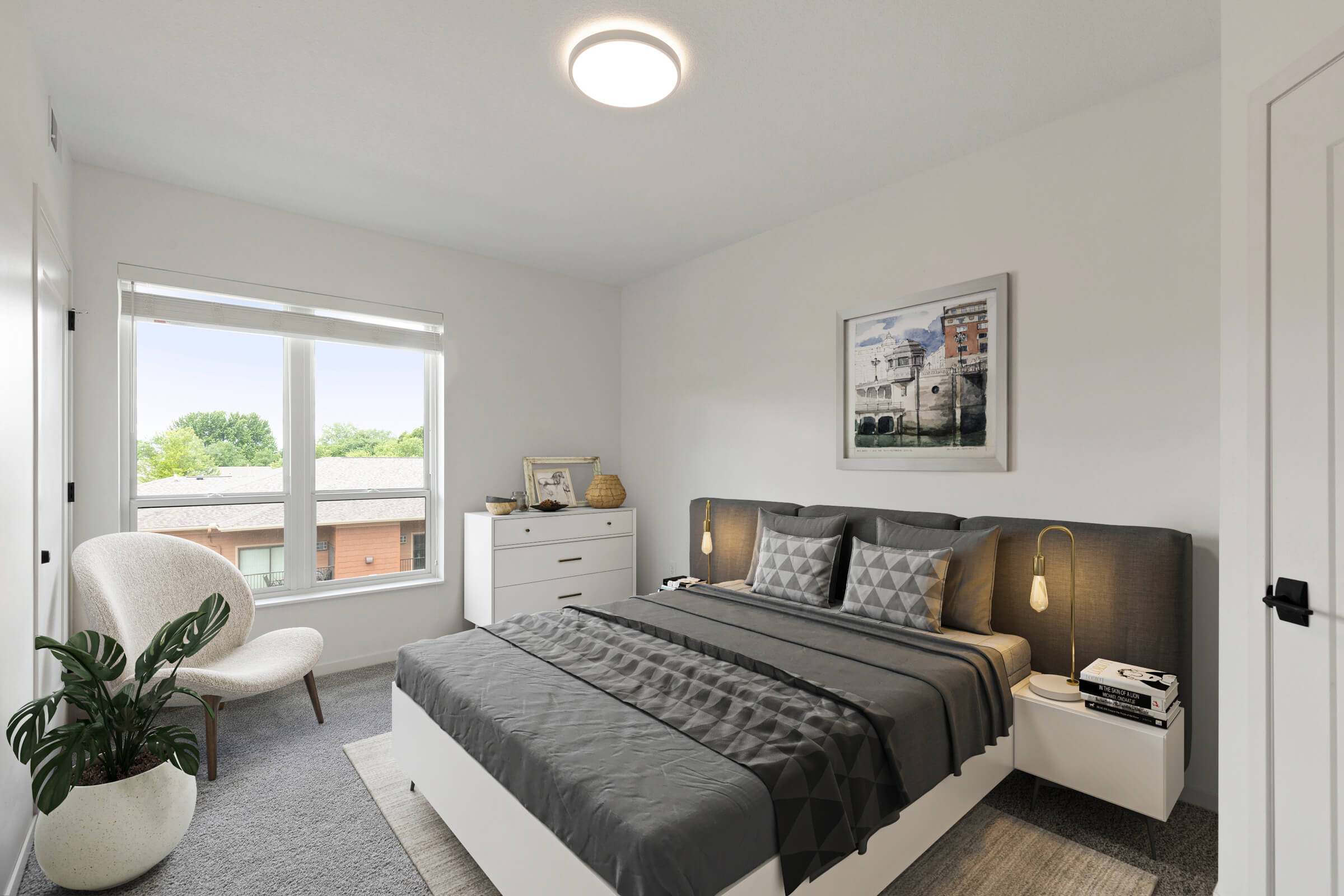 Staged bedroom with gray bedding and window view