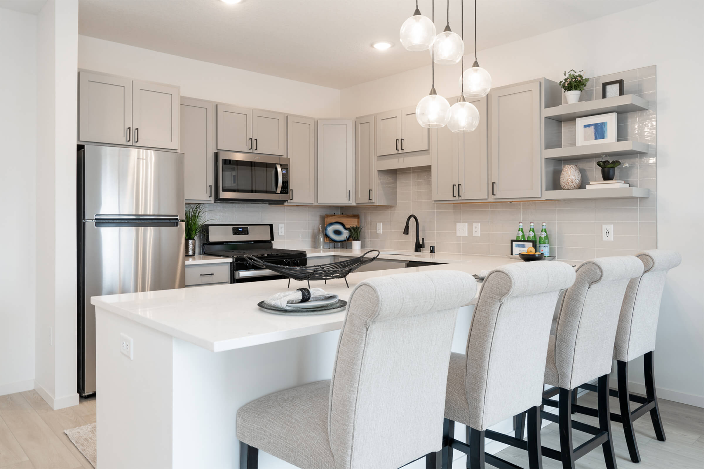 Kitchen with bar seating and pendant lights