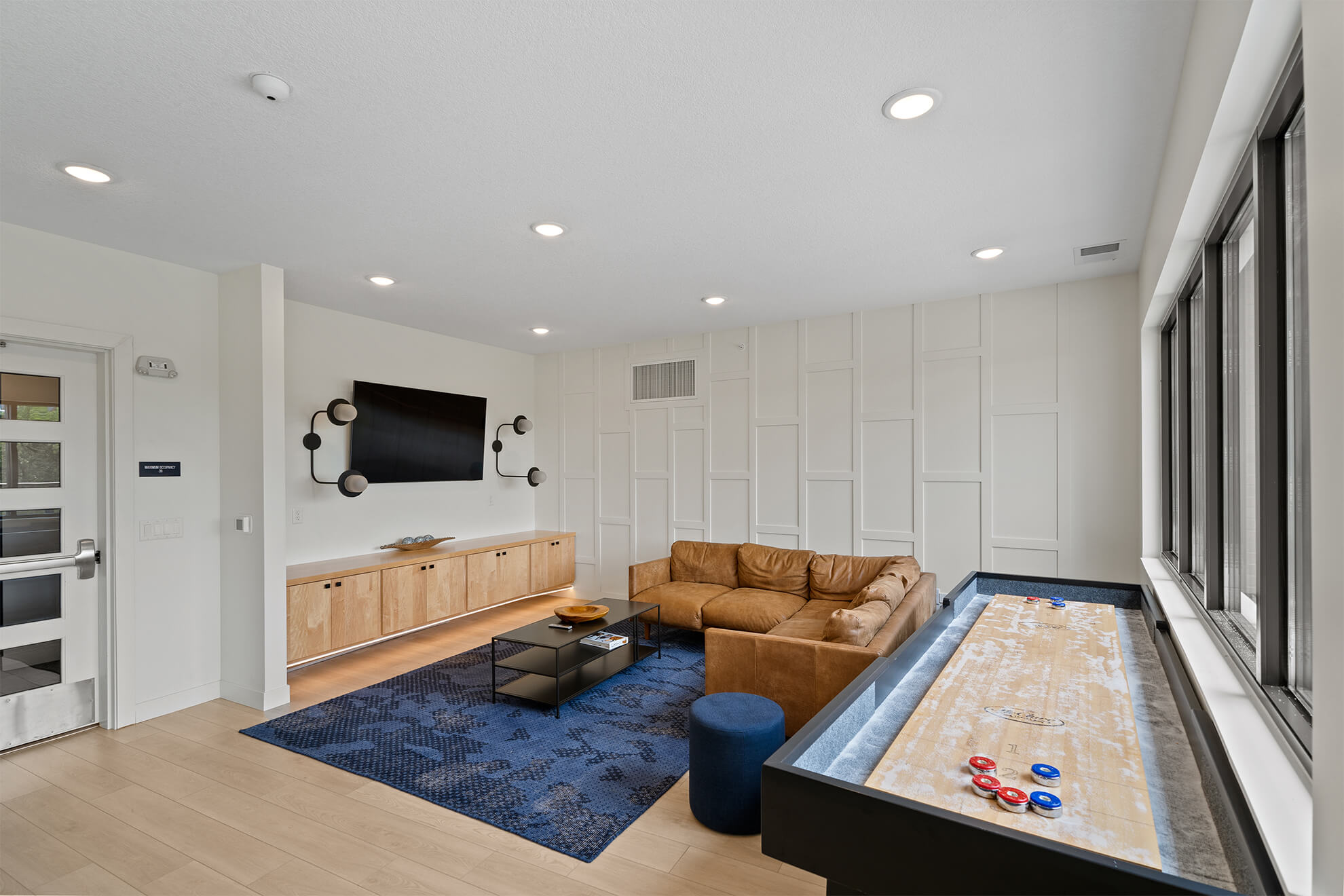 Living room with large window and neutral decor