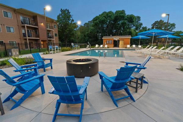Swimming pool at dusk with glowing lights and reflection