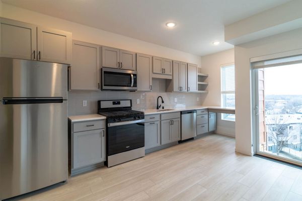 Kitchen with stainless steel appliances and large window