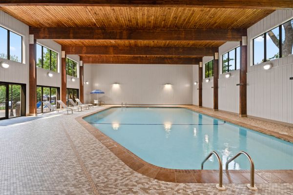 Spacious indoor swimming pool with tall windows