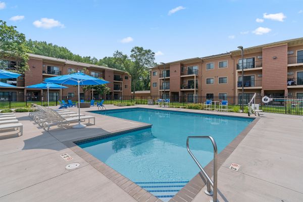 Close-up of outdoor pool with tiled edges and patio seating