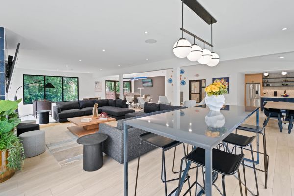 Social lounge with sectional sofas, tall tables, and bright contemporary interior design