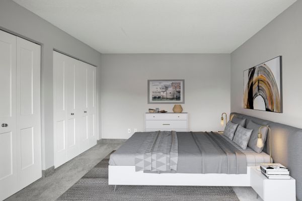 Staged bedroom with double closet and contemporary artwork